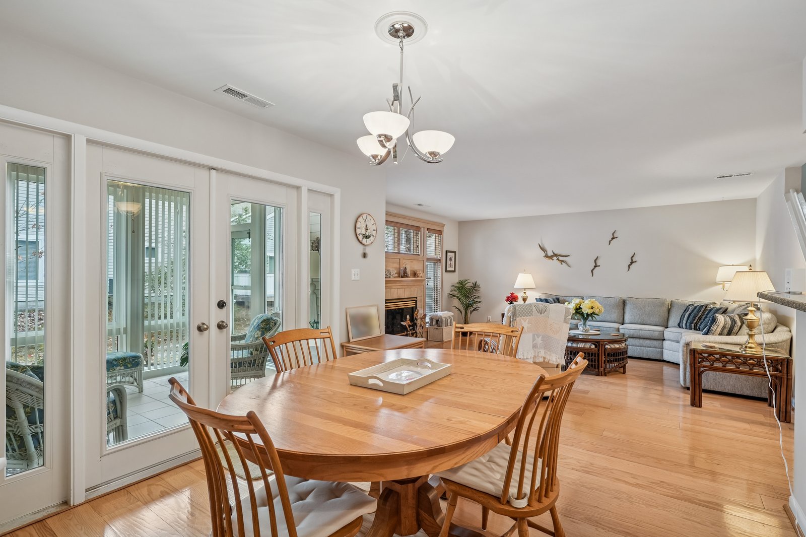 Relax in your open-concept living space with elegant dining table, cozy sectional, and fireplace. French doors open to your private patio.