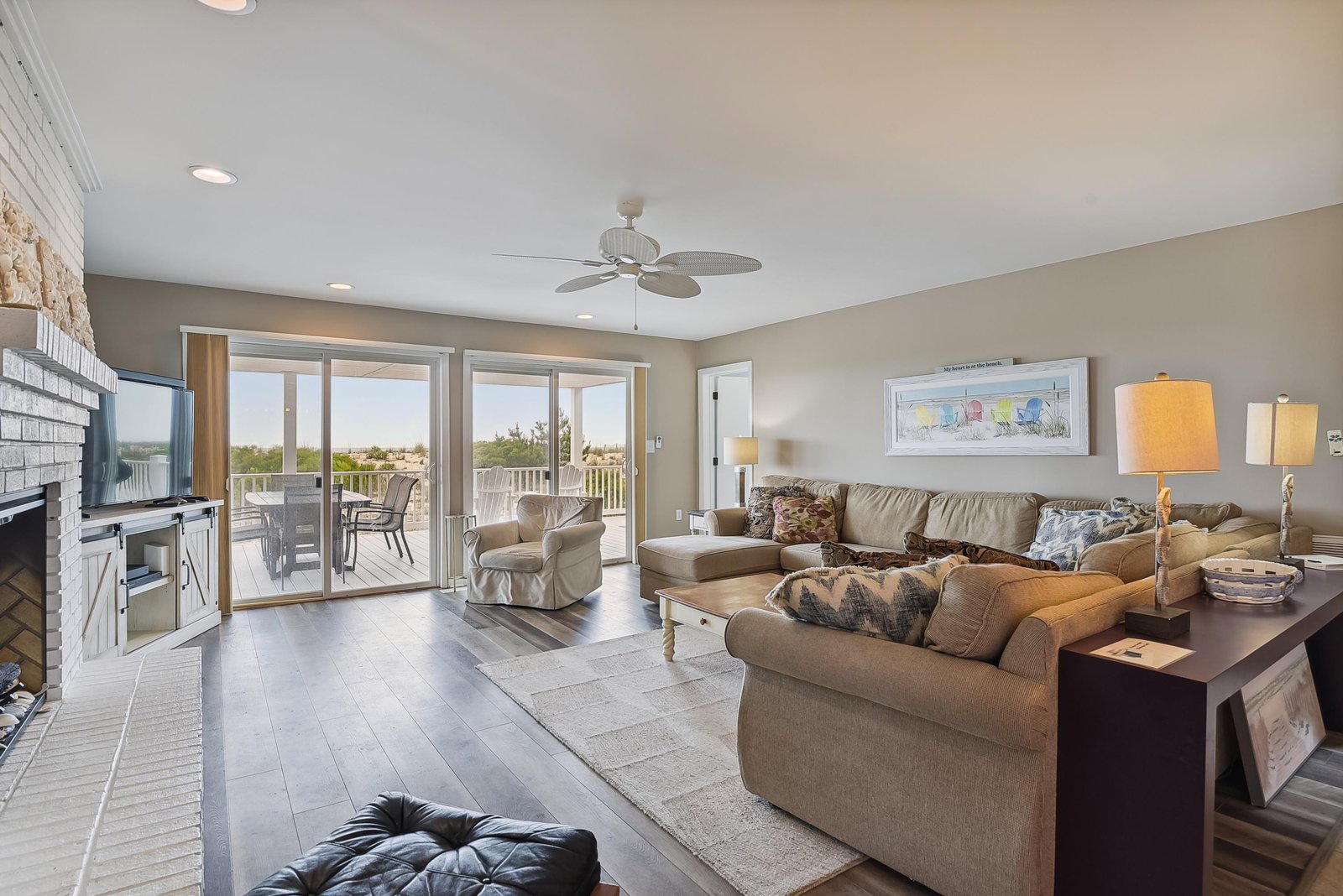 Sink into comfortable seating in this bright living room, where floor-to-ceiling glass doors frame the balcony and invite natural light to fill your space.