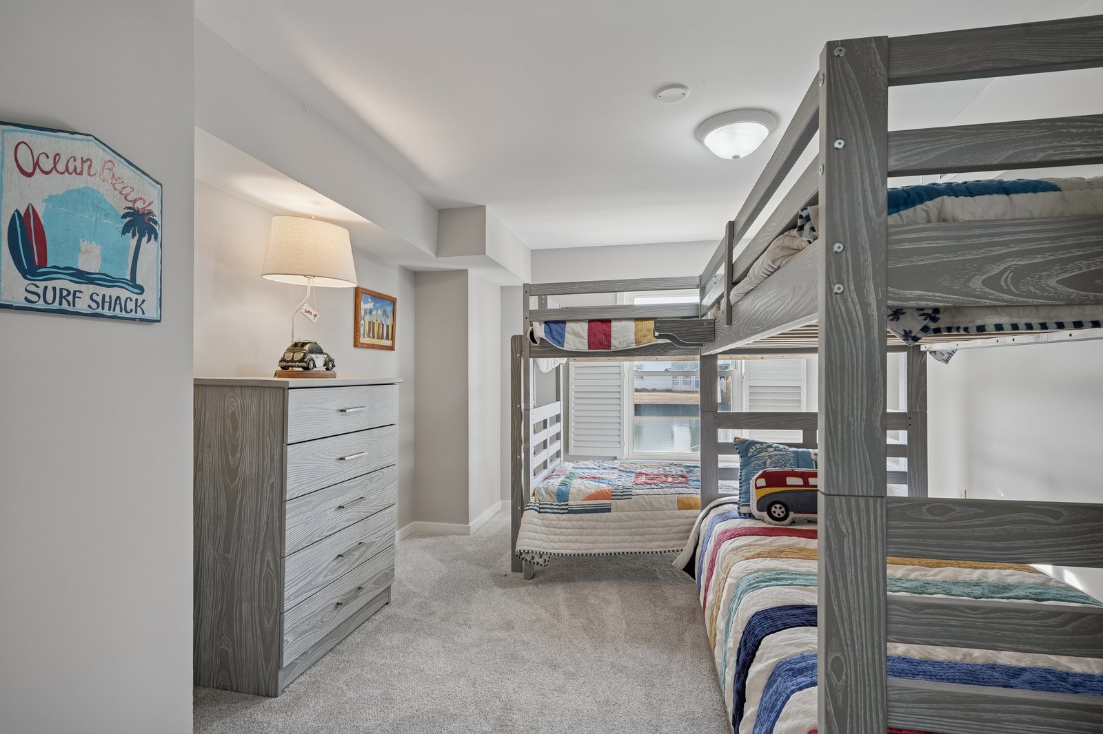 Your kids will love this surf-themed bunk room where beach adventures continue through bedtime stories and sweet dreams.