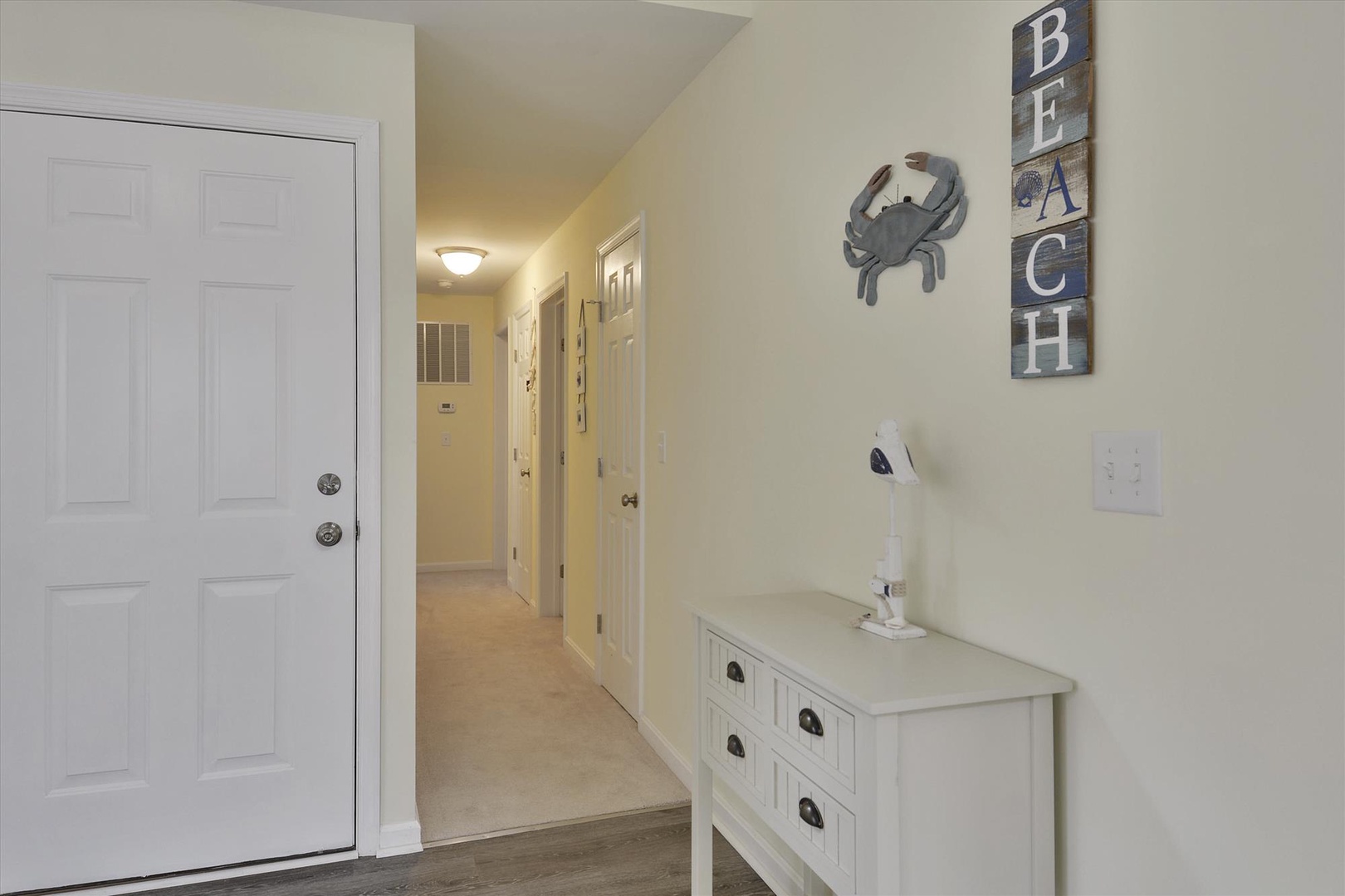 Step into your coastal retreat, where beach-themed décor and a welcoming entryway set the tone for your relaxing vacation escape.