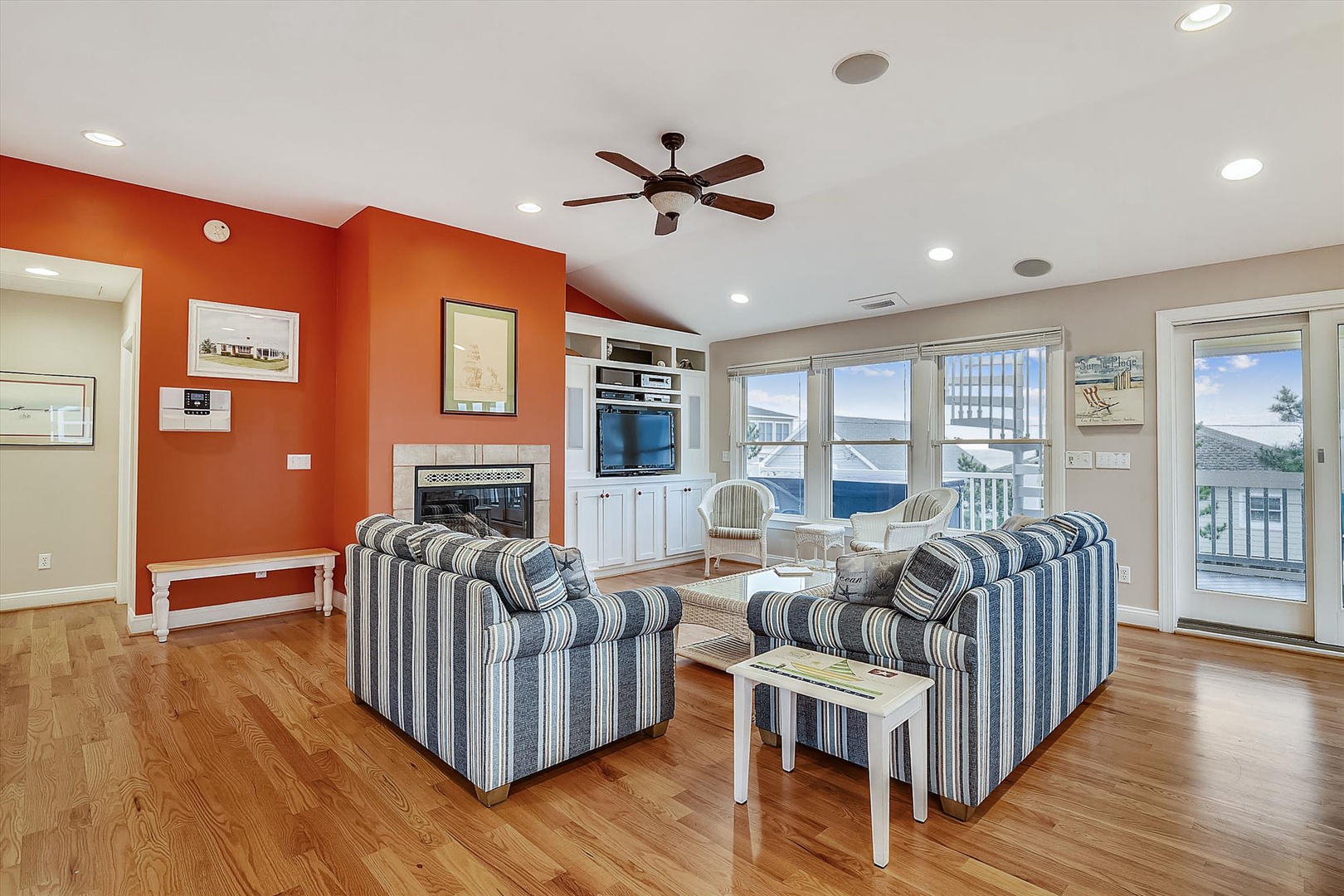 Relax in your bright, coastal living room where ocean breezes drift through glass doors and nautical accents welcome you home. Sink into plush striped armchairs and let the sea views inspire your beach getaway.