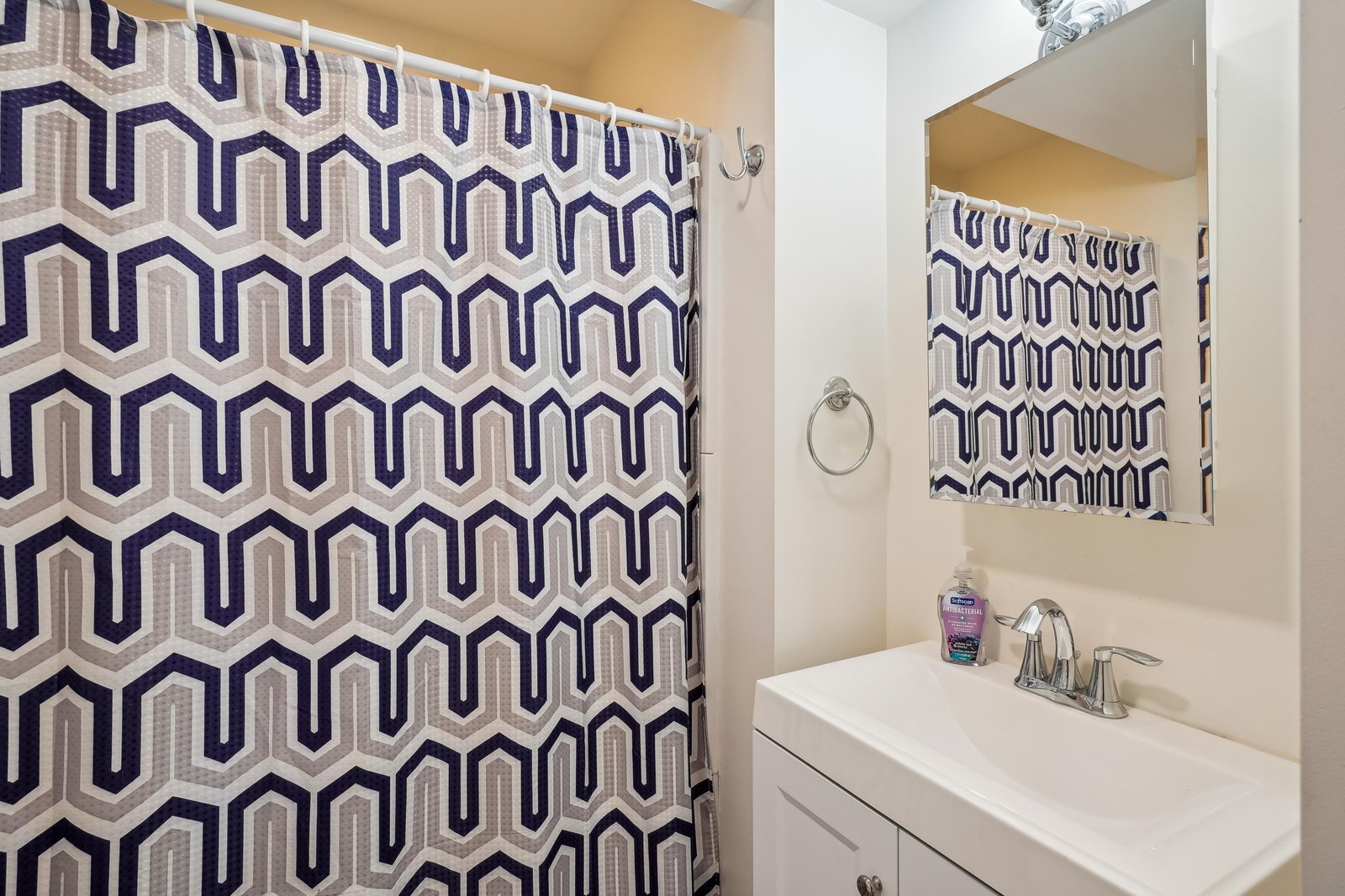 Step into your crisp, clean bathroom with modern geometric style. The spacious vanity and mirror give you plenty of room to freshen up before a day of adventure.