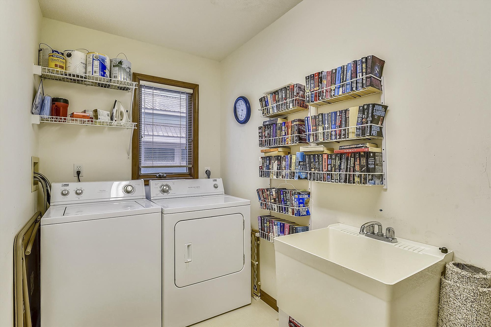 Your laundry stays fresh in this convenient space with washer, dryer, and utility sink—plus browse the extensive DVD collection during downtime.