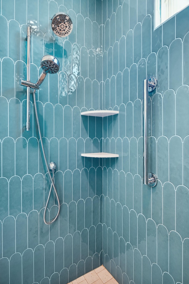 Step into your private retreat with stunning ocean-inspired tile and a dual showerhead for the ultimate refresh.