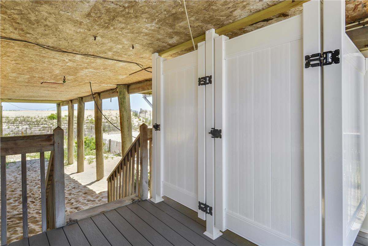 This covered beachfront deck provides direct access to the sand, with storage space for your beach gear and gear rinse station. The upper level offers elevated views of the shoreline.