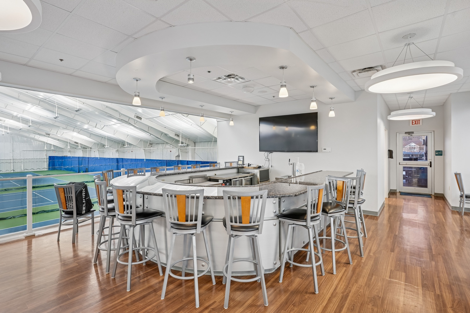 Watch the game from your elevated clubhouse seats with panoramic court views and granite bar seating.