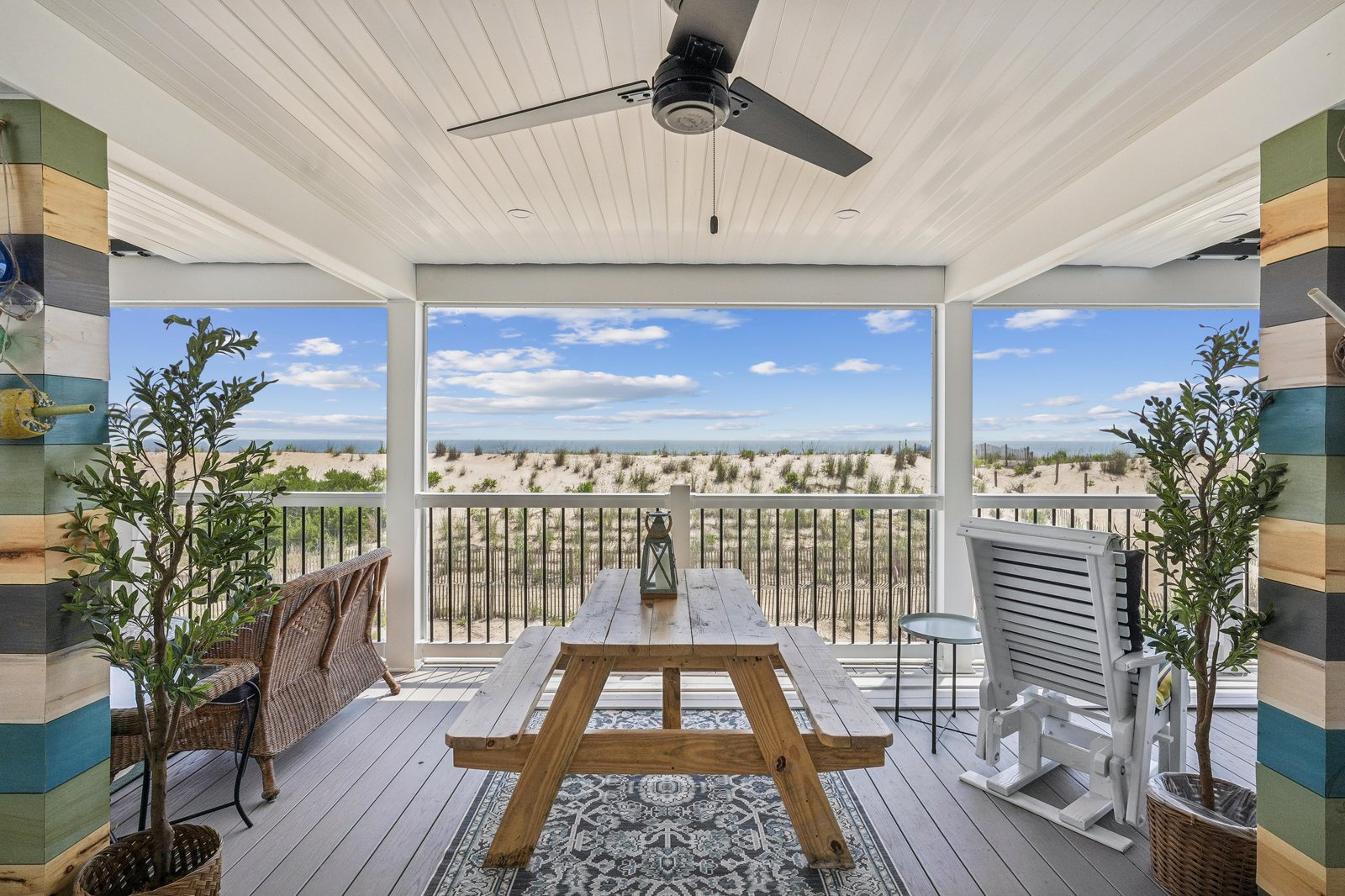 Unwind on your private covered porch with sweeping views of natural dunes and the ocean beyond. Coastal breezes and a comfy rocking chair await your afternoon retreat.