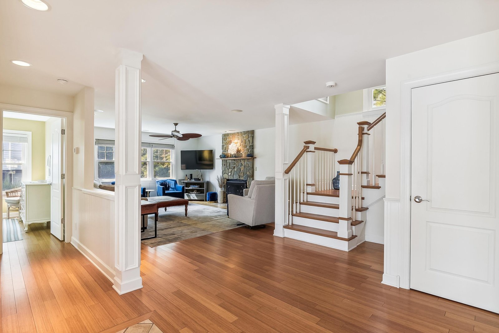 Step into this bright, open living space where warm hardwood floors and elegant millwork welcome you home. Relax by the stone fireplace or unwind in the inviting seating area—your perfect retreat after exploring the area.