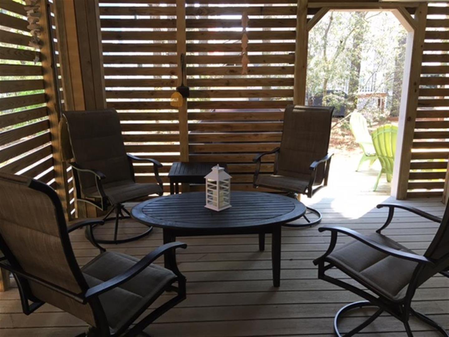 Step outside to your private, covered deck where four plush lounge chairs circle a fire table, creating the perfect spot to unwind with morning coffee or starlit evenings.