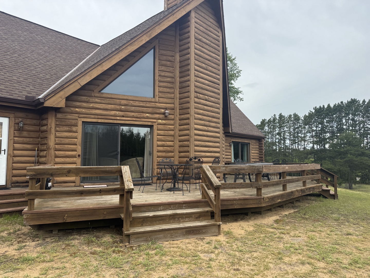 Spacious wooden deck featuring patio seating