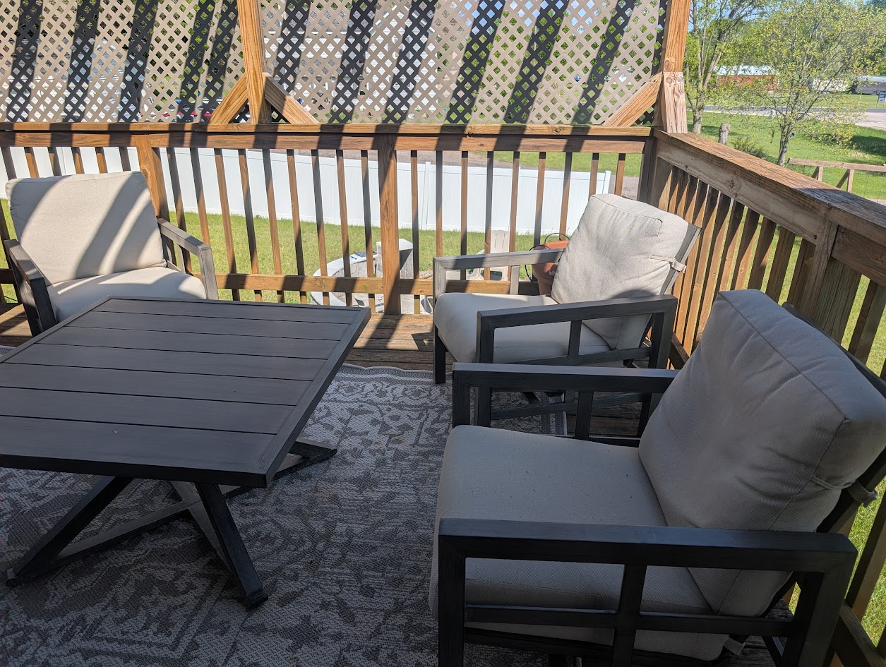 Step onto your private balcony and settle into cushioned seating, perfect for morning coffee or evening relaxation while enjoying peaceful neighborhood views and fresh air.