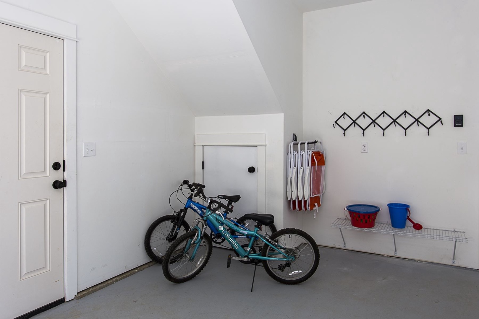 Garage with beach chairs, bikes, and sand castle toys