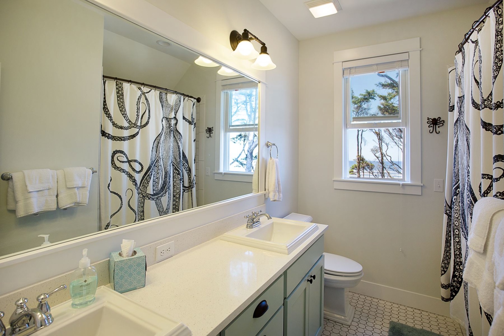 King primary ensuite bathroom with double vanity sink and an ocean view