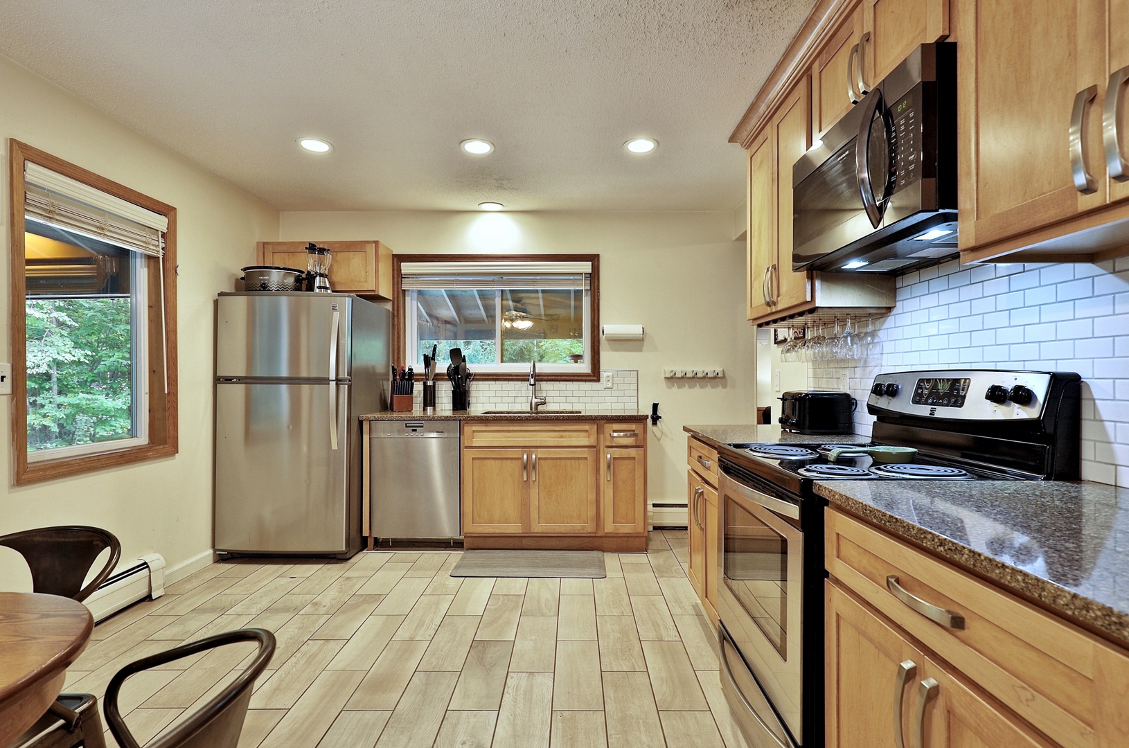 Full kitchen with fridge, mini-fridge, stove, microwave