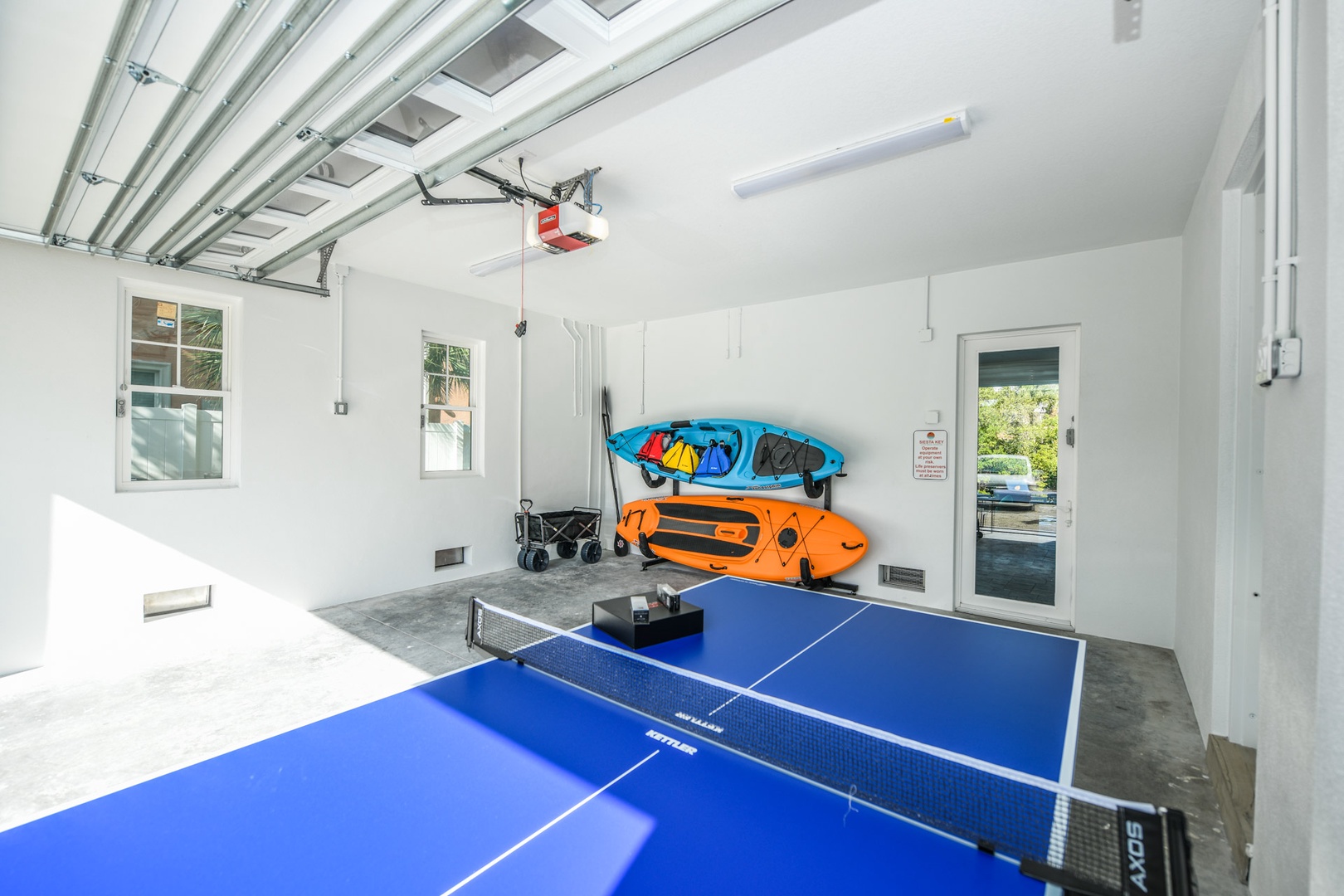 Garage area with ping pong table, kayak, and paddleboard