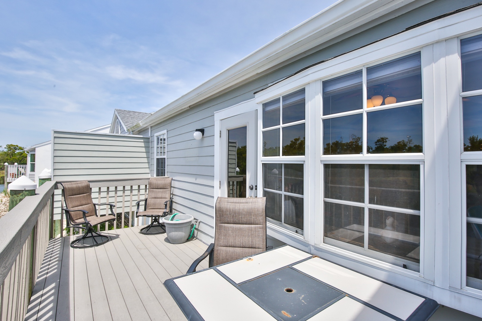 Step outside onto your private deck where cushioned seating invites you to unwind with morning coffee or evening conversations under open skies.