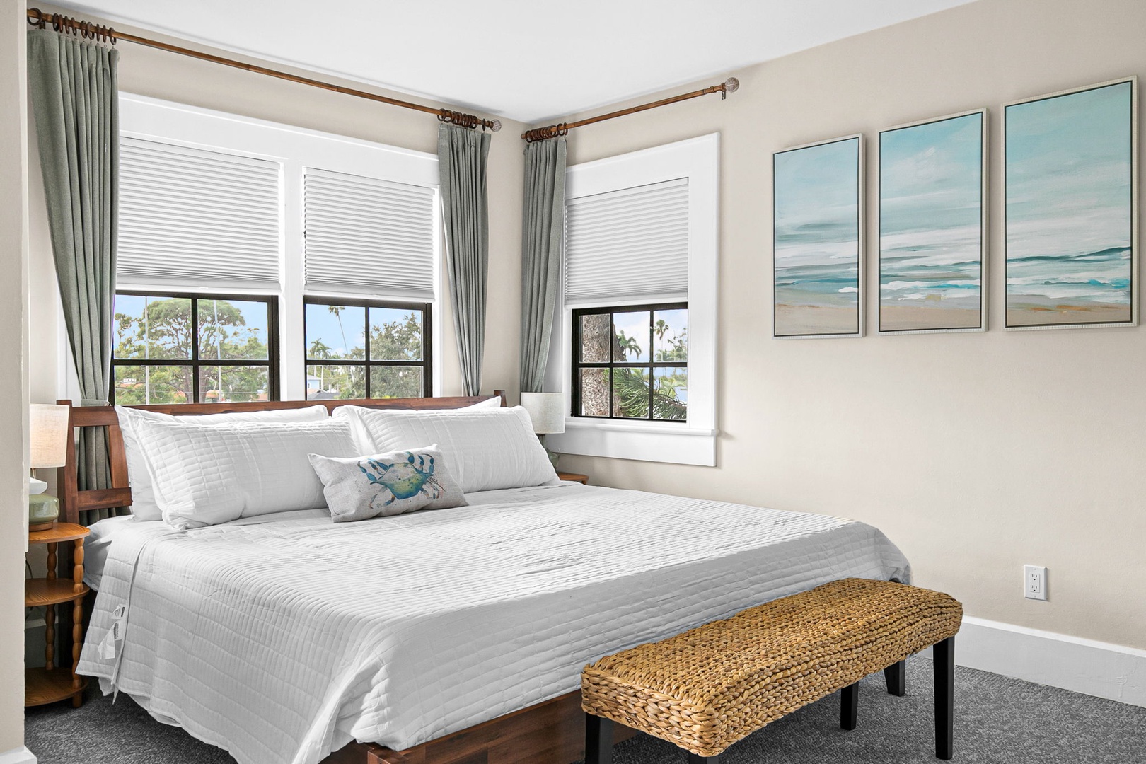 Wake up to tropical tree views from your bright, airy bedroom with crisp linens and soothing coastal artwork for peaceful mornings.