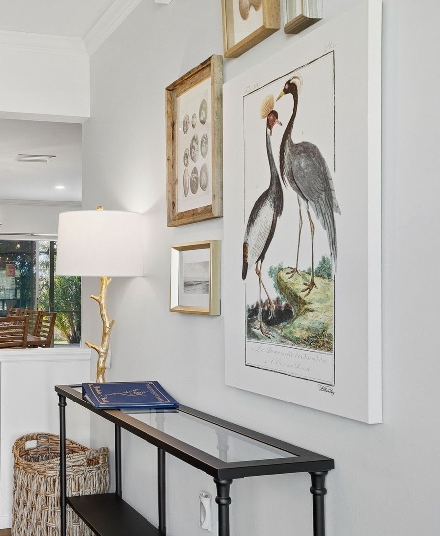 Gallery wall features elegant prints and coastal art, creating a sophisticated yet welcoming atmosphere in your bright living space.