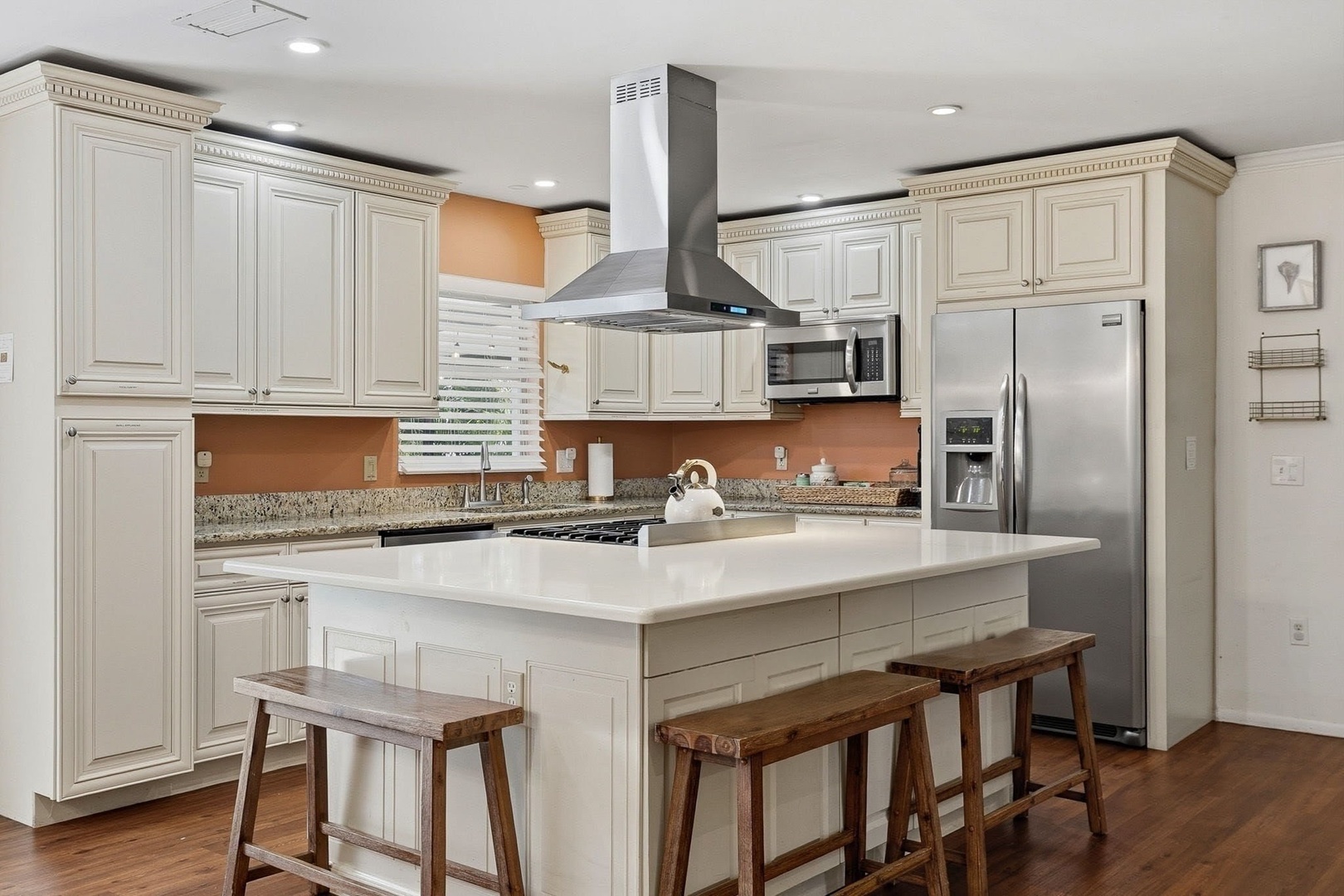 Your gourmet kitchen awaits with granite counters, stainless appliances, and a spacious island perfect for cooking memorable meals together.