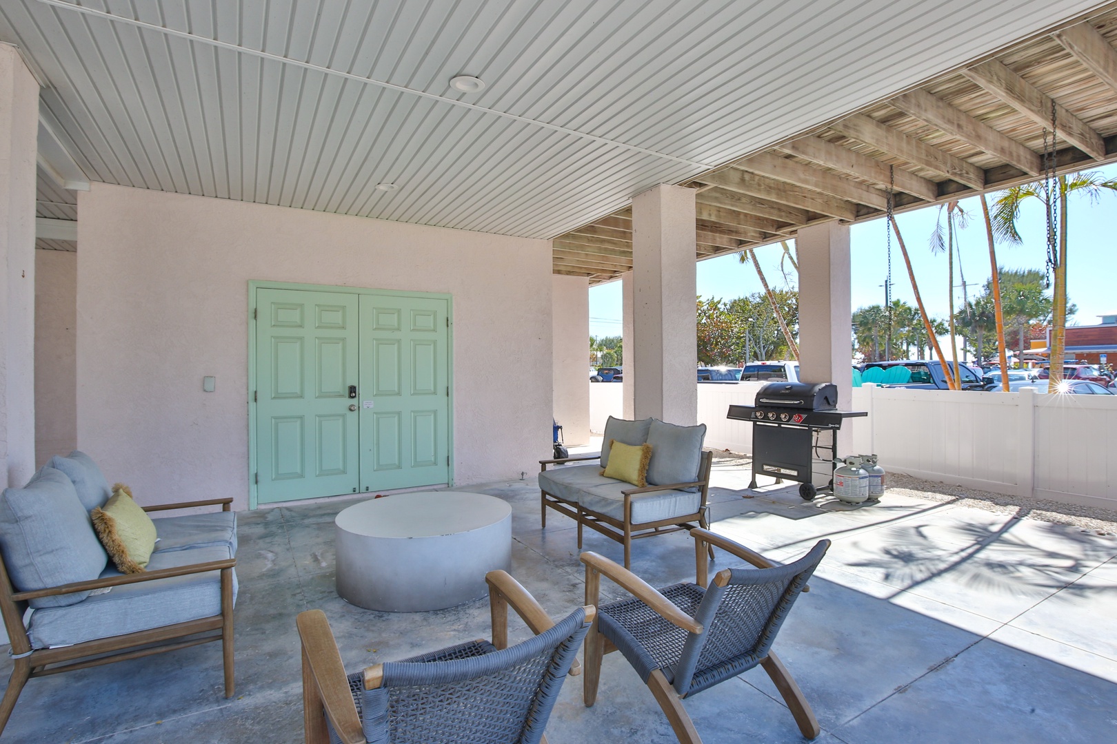 Your covered patio offers stylish comfort with modern seating and a BBQ grill, perfect for relaxing or grilling meals outdoors.