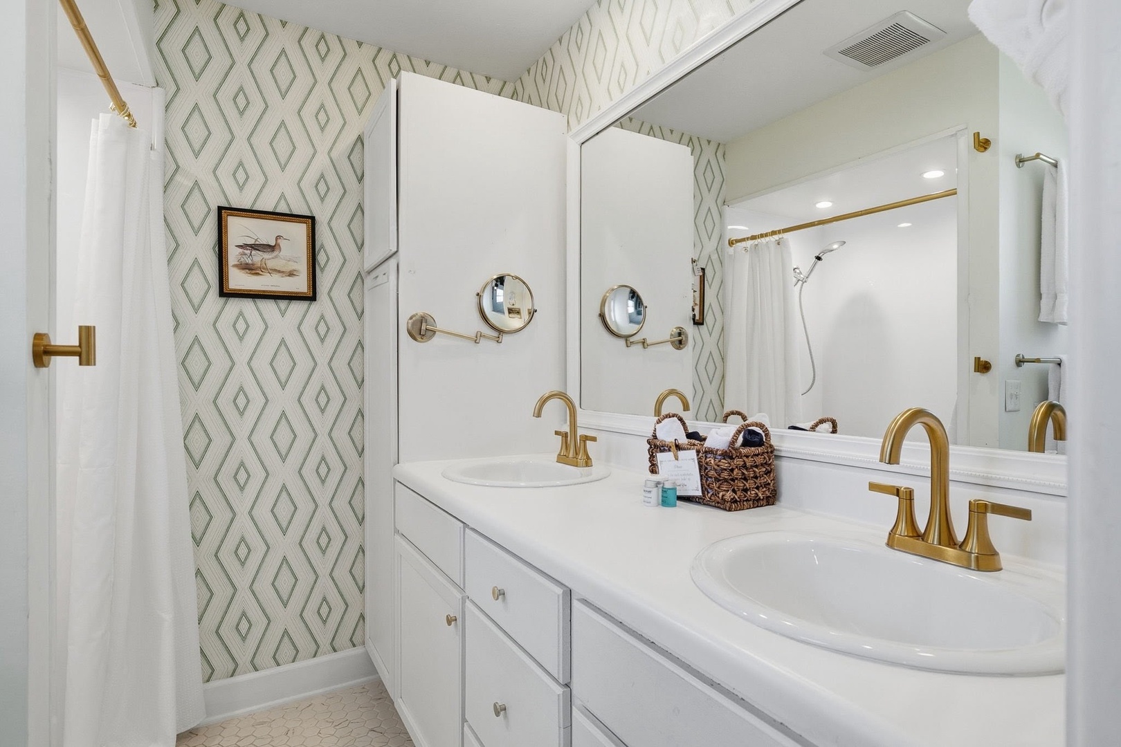 Step into your elegant spa-like bathroom with dual vanities, gold accents, and chic geometric wallpaper that creates a luxurious morning routine.