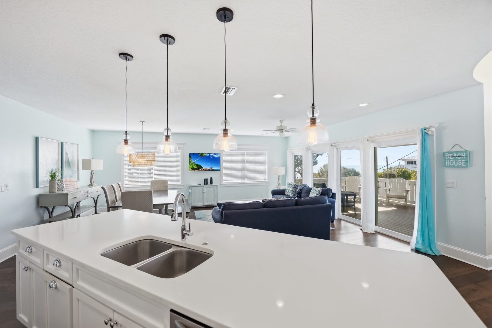 Your open-concept kitchen flows seamlessly into the living area, where modern pendant lights create ambiance for cooking and relaxing together.