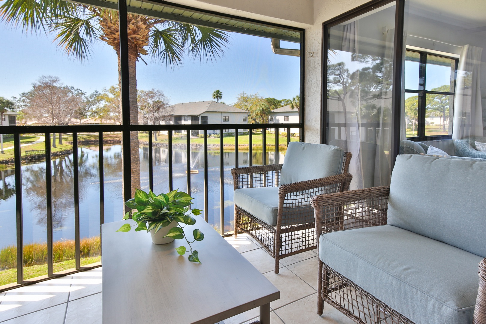 Relax on your private balcony with stunning water views, where comfortable seating invites peaceful moments overlooking the tranquil lake.