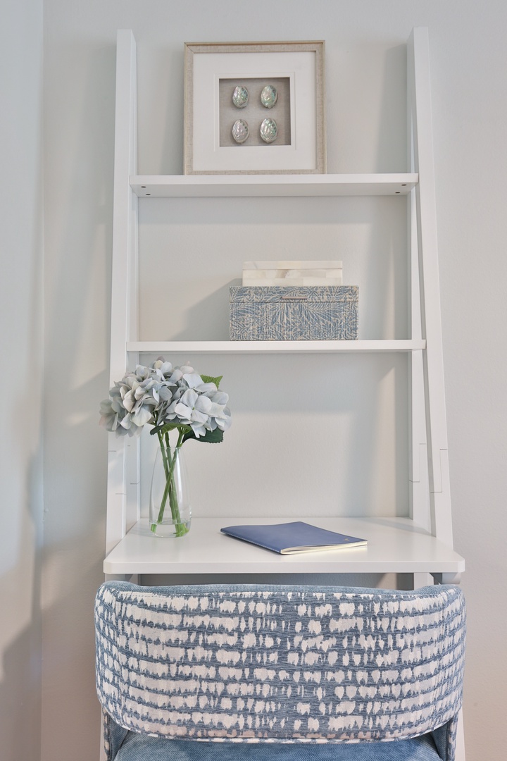 Your personal workspace awaits with thoughtful details like fresh blooms and coastal art to inspire productivity.
