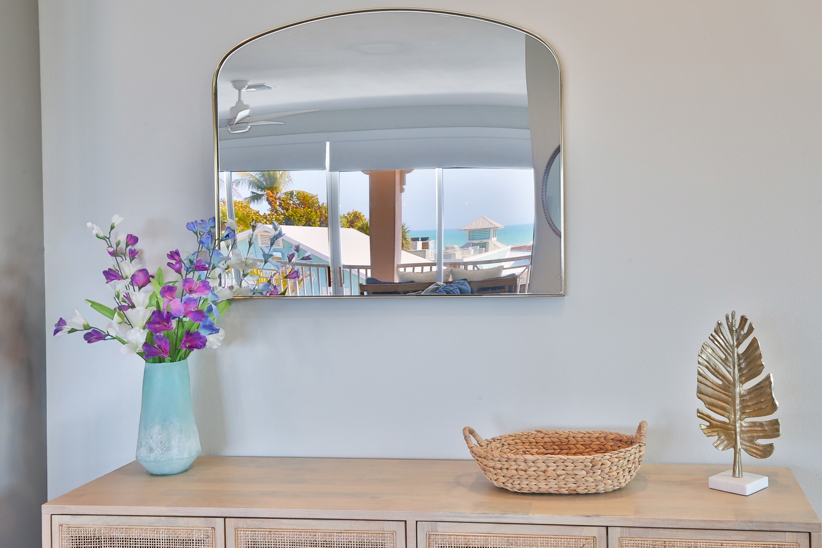 Refresh yourself at this stylish vanity while enjoying glimpses of tropical paradise through the mirror's reflection.