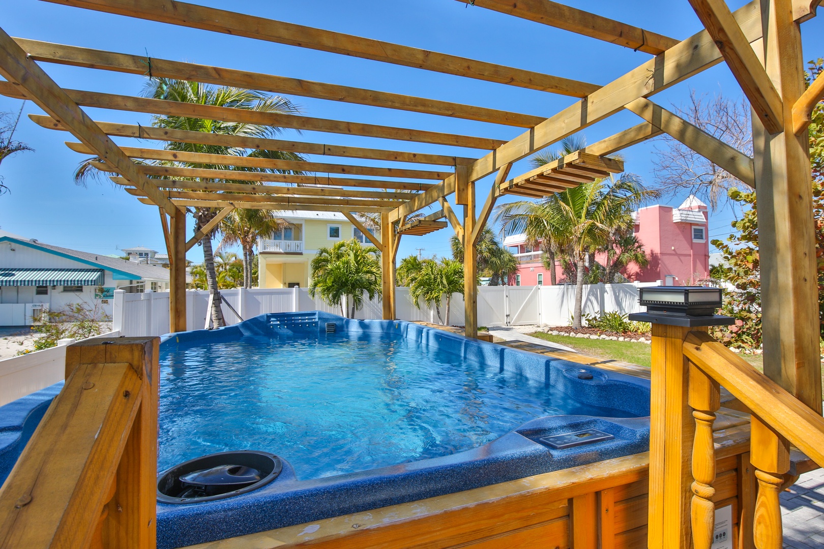 Soak in your private hot tub under the tropical sun, surrounded by swaying palms and colorful Caribbean architecture.