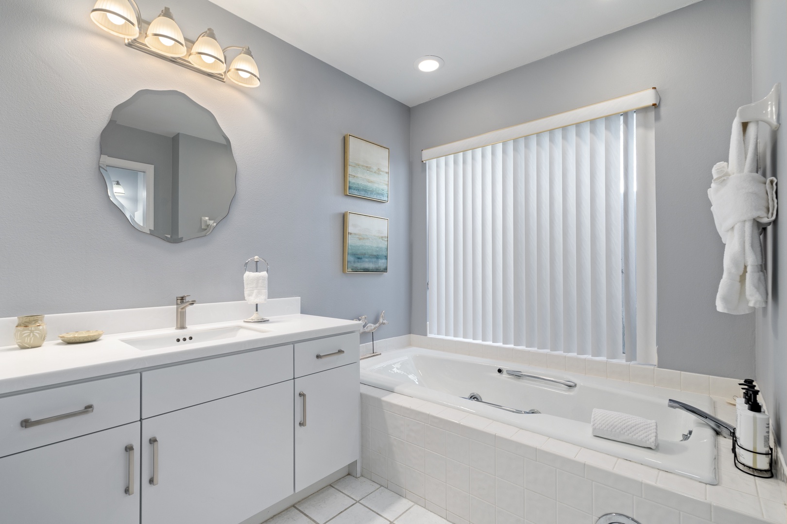 Unwind in your private spa-like retreat with a deep soaking tub, elegant vanity, and soft lighting that sets the perfect mood for relaxation.