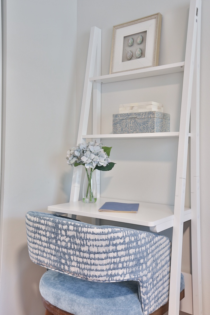 Your private corner workspace awaits with thoughtful touches—fresh flowers brighten your productive moments.