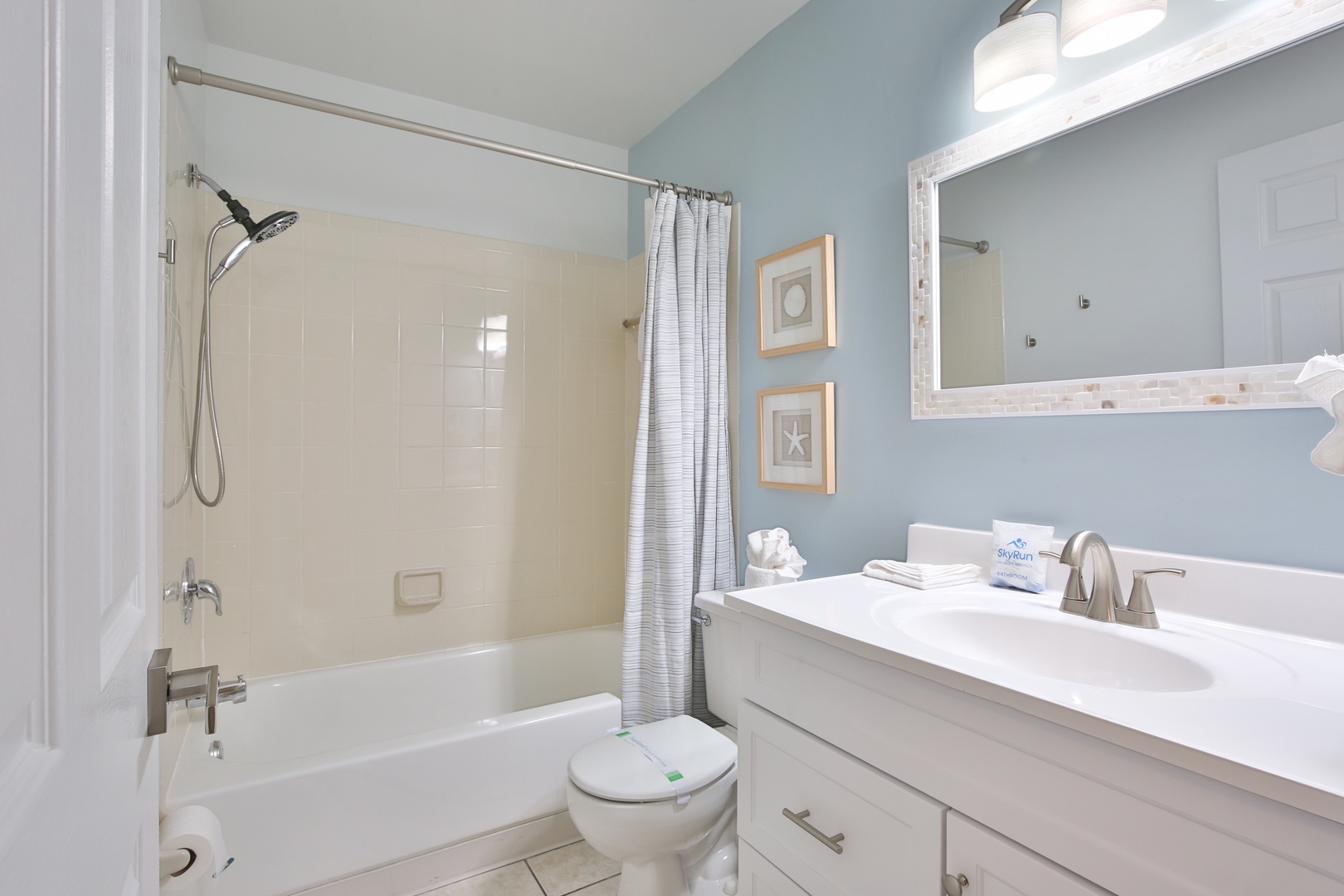 Fresh towels await in your beautifully appointed bathroom, featuring a spacious tub-shower combo perfect for relaxing after your adventures.