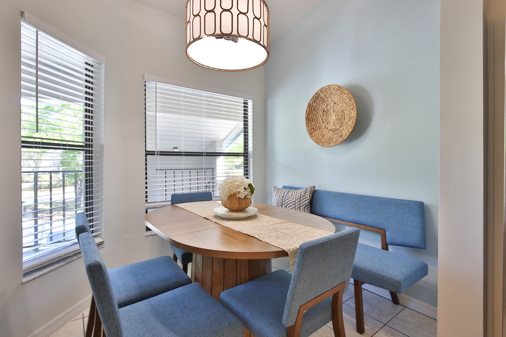 Your stylish dining nook awaits with modern blue seating and warm wood touches, perfect for morning coffee or intimate meals.