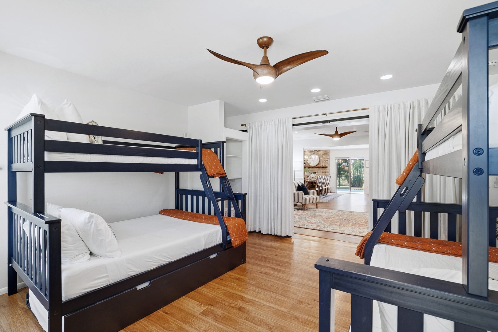 Your kids will love this bright bunk room with ceiling fan and cozy common area just beyond.