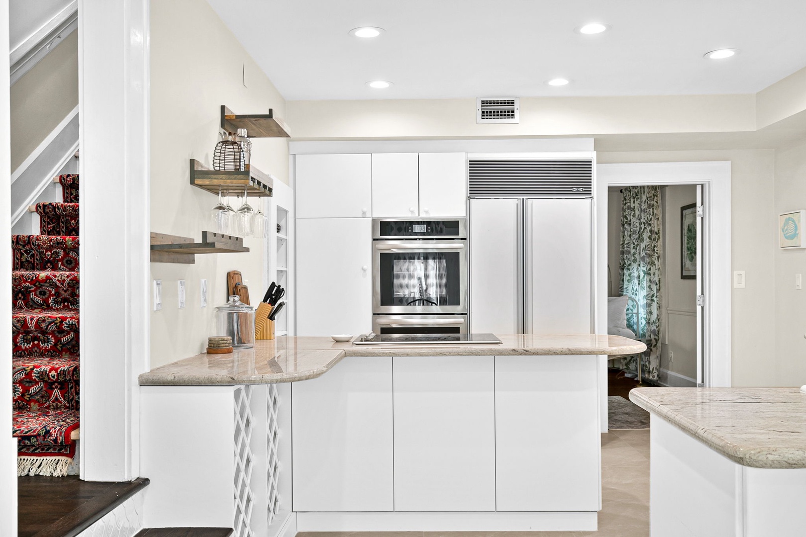 Your sleek modern kitchen awaits with pristine white cabinets, granite countertops, and premium stainless steel appliances for effortless meal preparation.