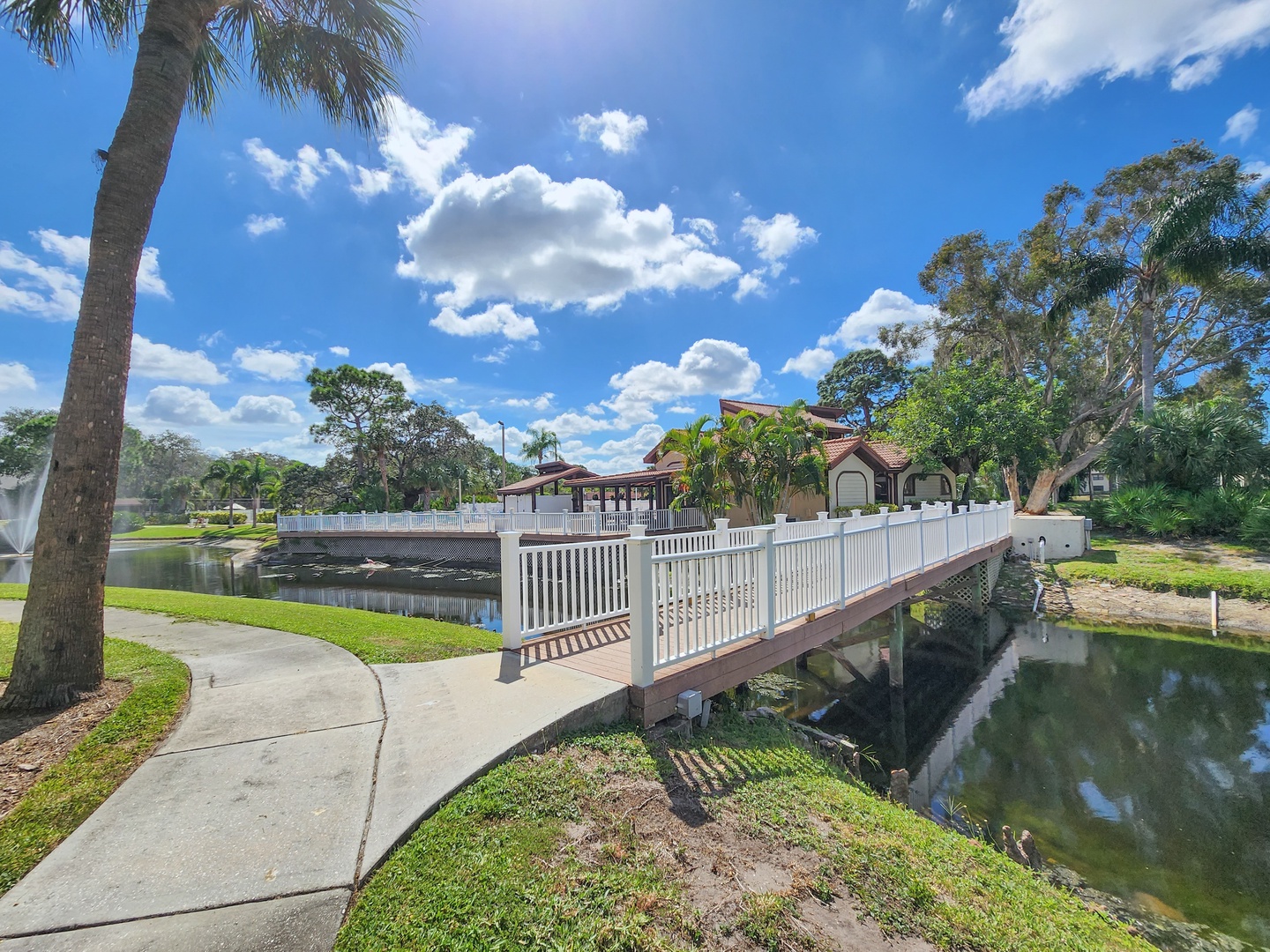 Charming waterfront neighborhood with tropical landscaping and peaceful walking paths through residential canal system.