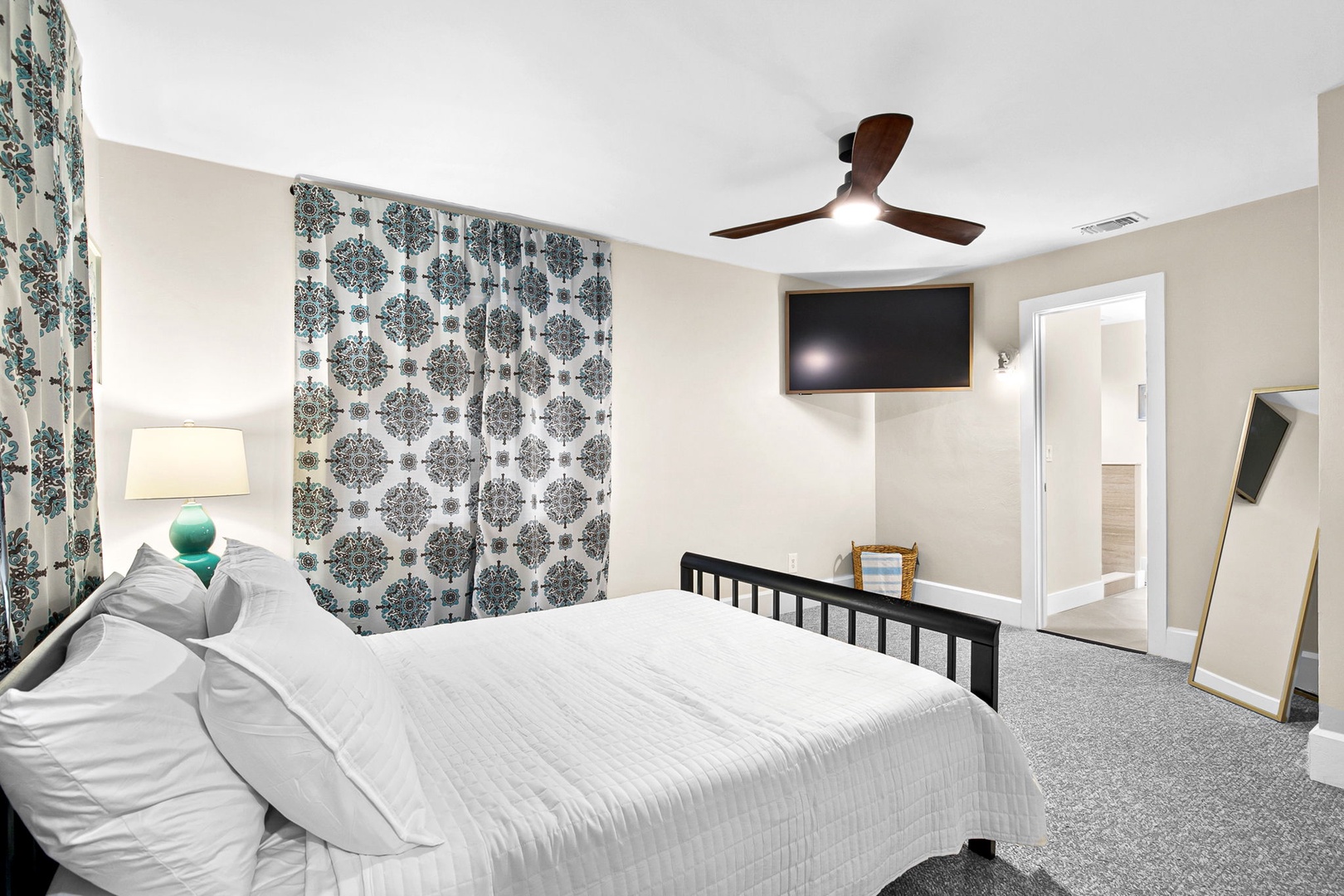 Your spacious bedroom features crisp linens, gentle ceiling fan breezes, and modern touches like wall-mounted TV for complete relaxation.