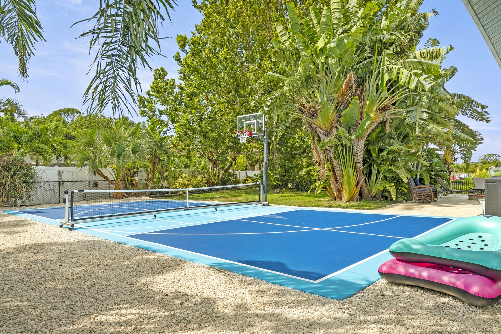 Challenge your travel companions to a friendly match on your private sports court, surrounded by lush tropical palms and sunny skies—perfect for active days and playful competition.