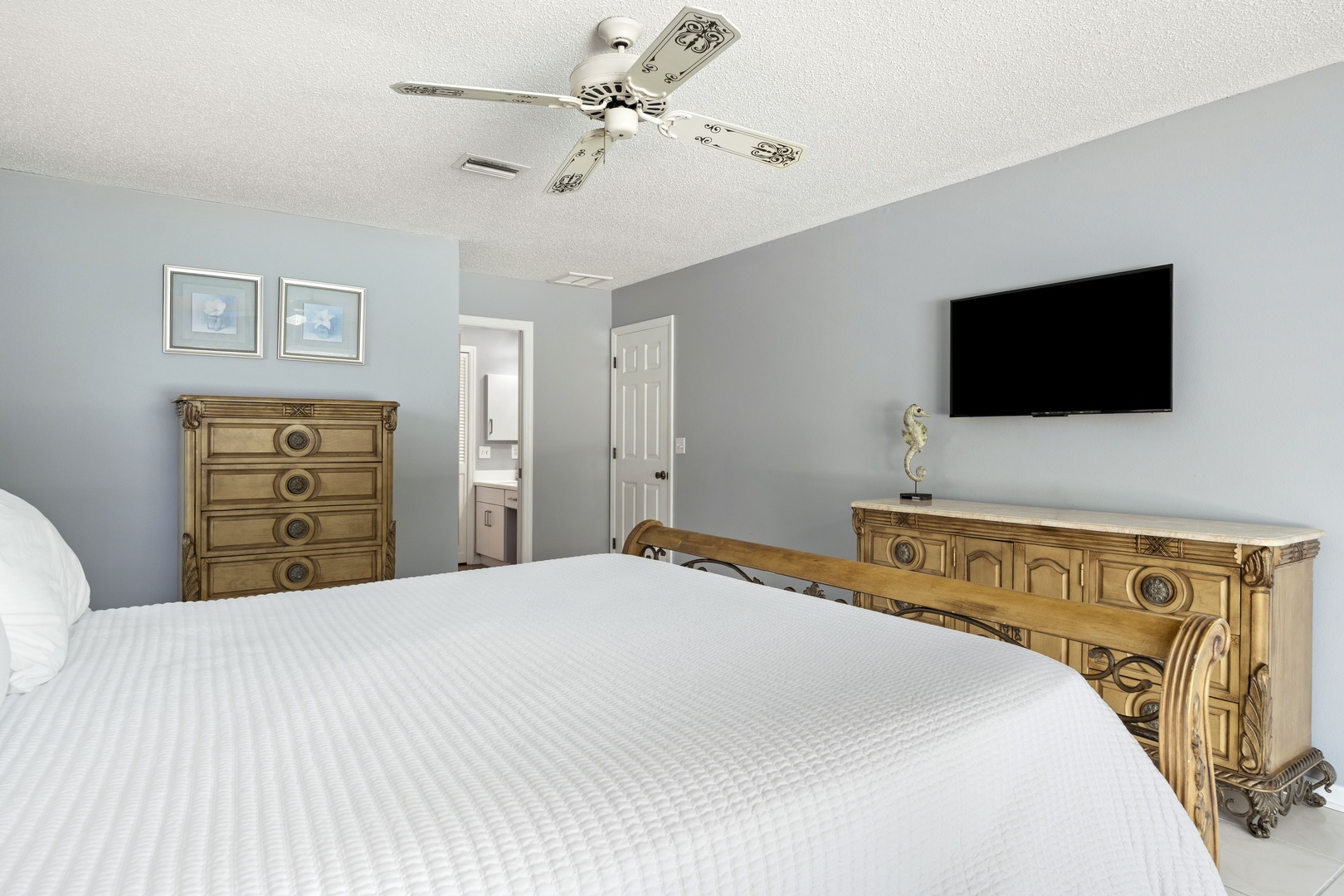 Unwind in this peaceful bedroom with a plush bed and coastal-inspired décor. Your private retreat features a flat-screen TV and charming nautical accents that set the tone for relaxation.