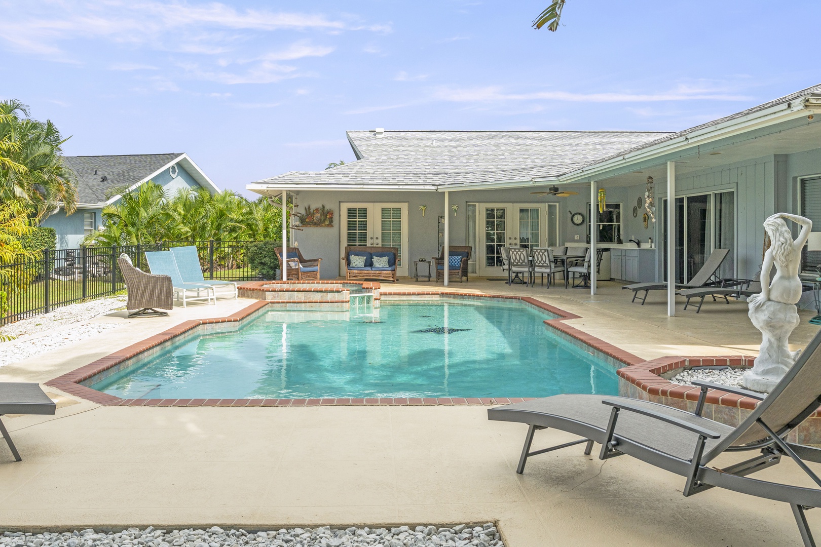 Your private oasis awaits—dive into the sparkling pool, soak up sunshine on the lounge chairs, and unwind beneath the covered patio where relaxation feels effortless.