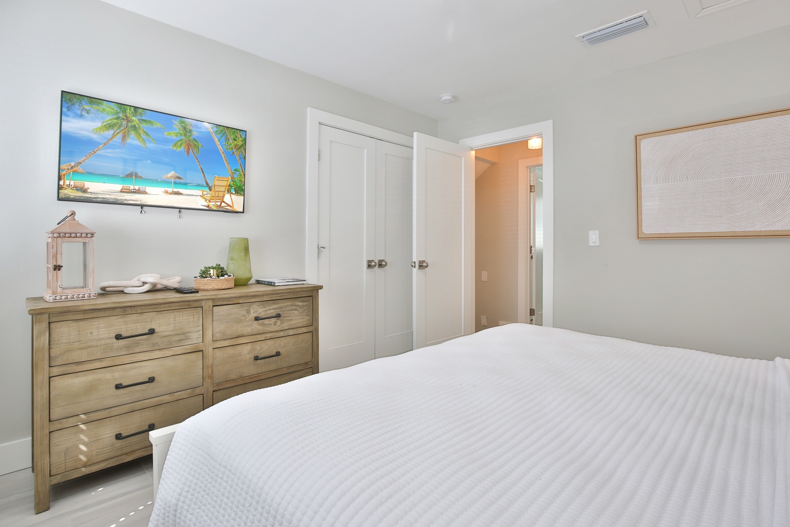 Unwind in your serene bedroom with crisp linens, tropical TV views, and thoughtful touches that make you feel right at home.