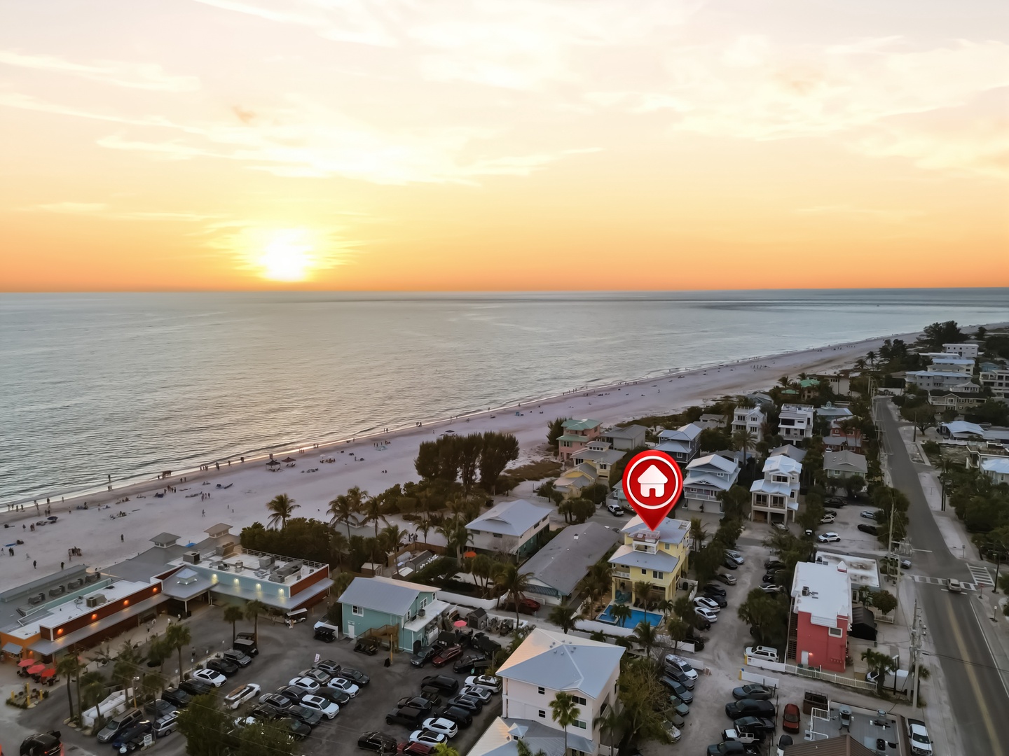 Stunning beachfront location just steps from pristine white sand and turquoise waters, with golden sunset views over the Gulf.