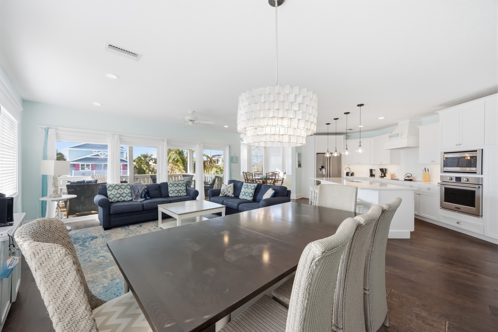 Relax in your open-concept living space where modern elegance meets tropical comfort, with designer lighting and stunning views.