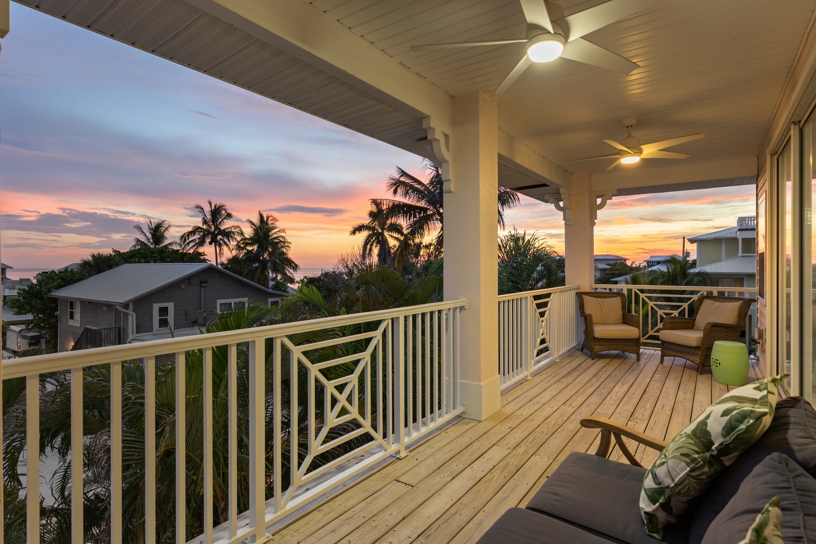 Unwind on your private balcony with comfortable seating as tropical breezes and stunning sunset views create the perfect evening retreat.