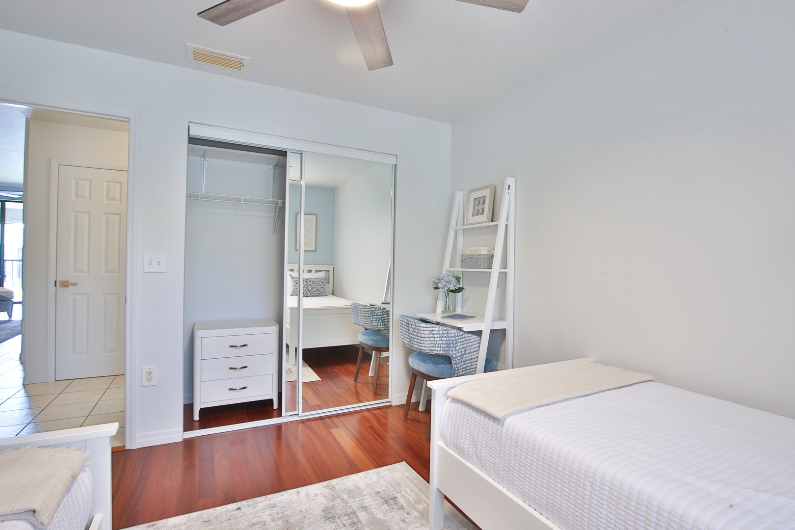 Your serene bedroom features rich hardwood floors and a mirrored closet that doubles your space, creating an airy retreat for restful nights.