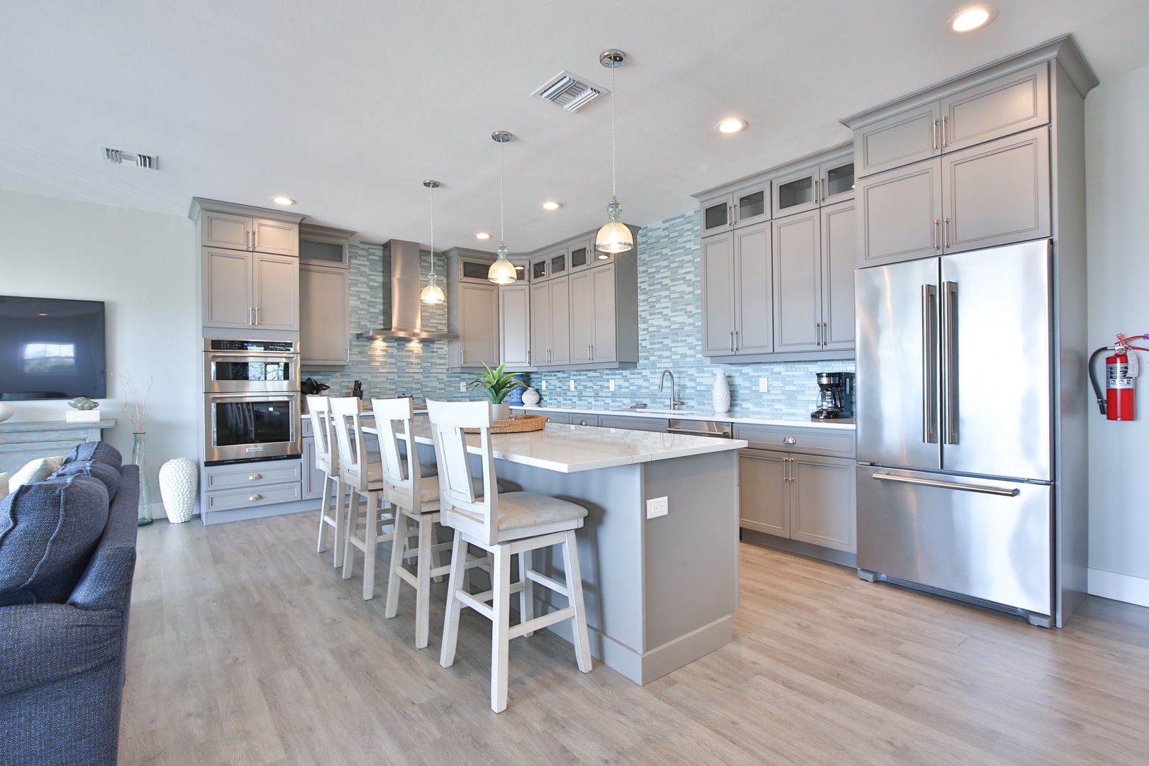 Step into your dream kitchen with stunning gray cabinetry, gleaming countertops, and a spacious island perfect for morning coffee or evening meals together.
