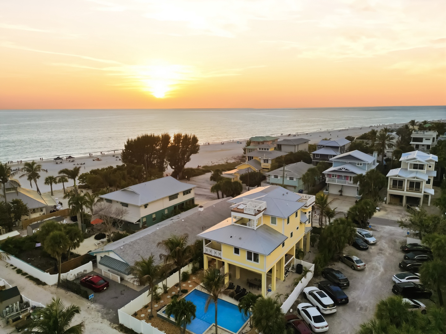 Stunning beachfront location with direct beach access and golden sunset views over the Gulf waters.