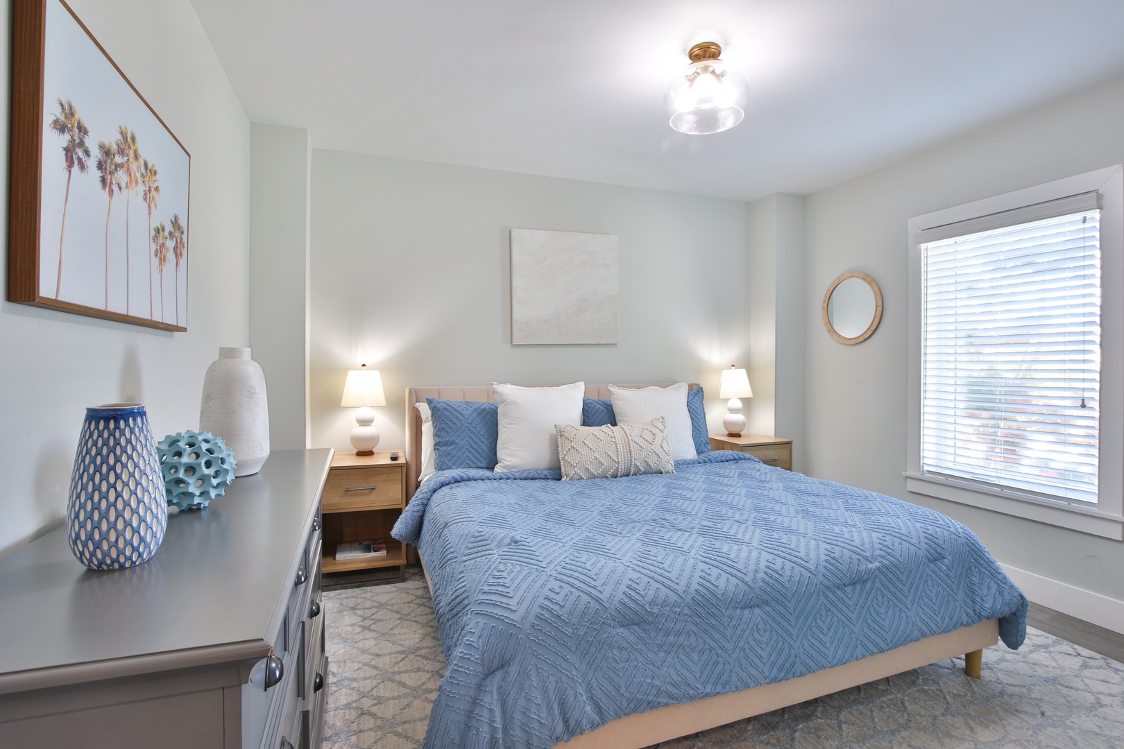 Drift into peaceful dreams in your serene bedroom, featuring coastal-inspired blue linens and warm wood accents.