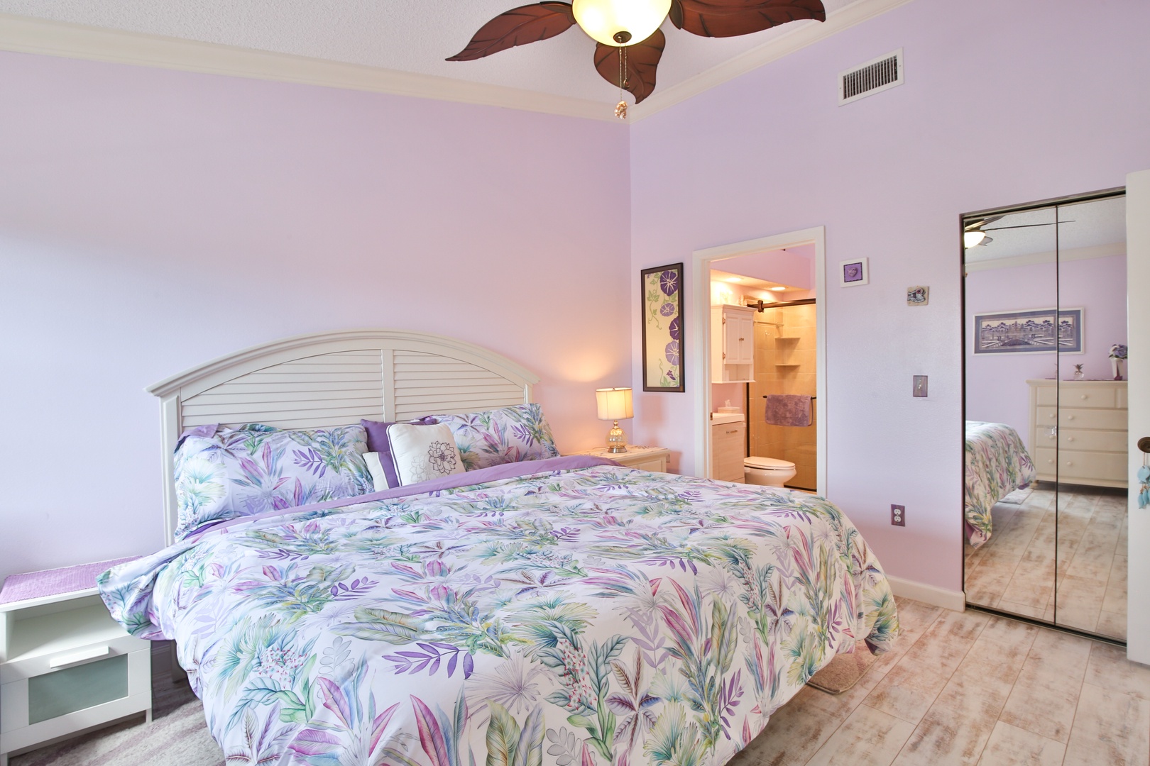 Unwind in your private retreat with a plush bed, tropical bedding, and a ceiling fan to keep you cool. Your ensuite bathroom awaits just steps away, and ample closet space lets you settle in effortlessly.